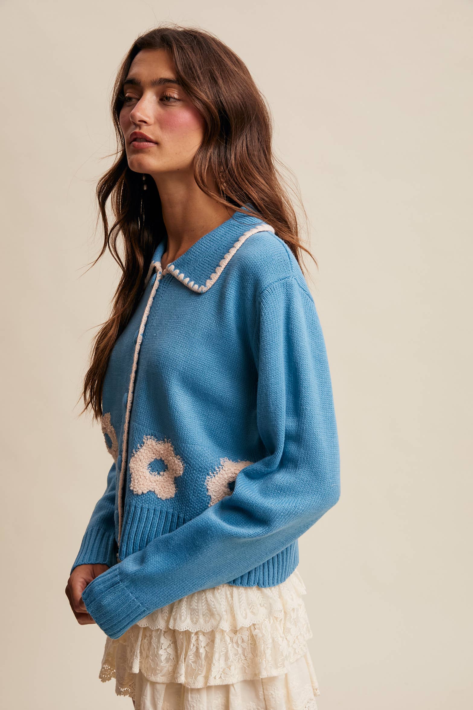 Women’s floral collar knit cardigan with button-front design, soft textured fabric, and contrast flower-patterned collar — stylish layering sweater for everyday wear.