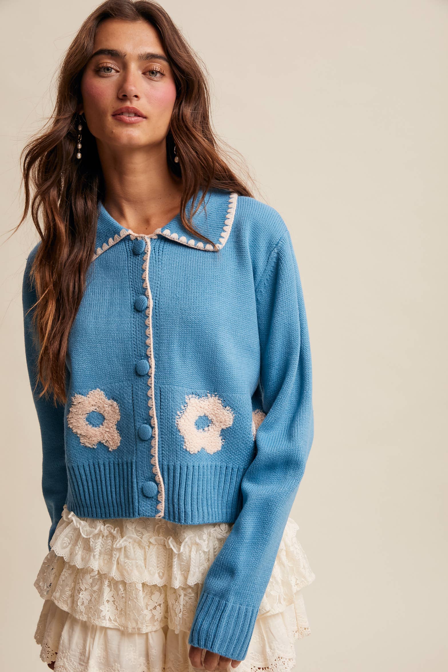 Women’s floral collar knit cardigan with button-front design, soft textured fabric, and contrast flower-patterned collar — stylish layering sweater for everyday wear.