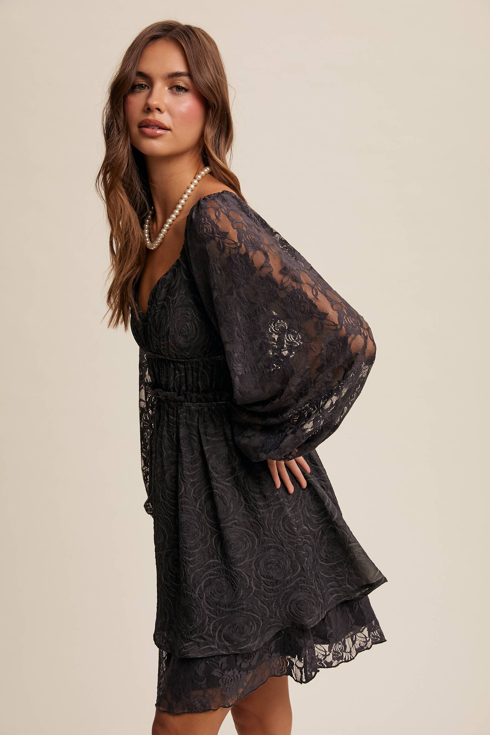 Side view of floral lace detailing and layered hem on The Midnight Lace Dress