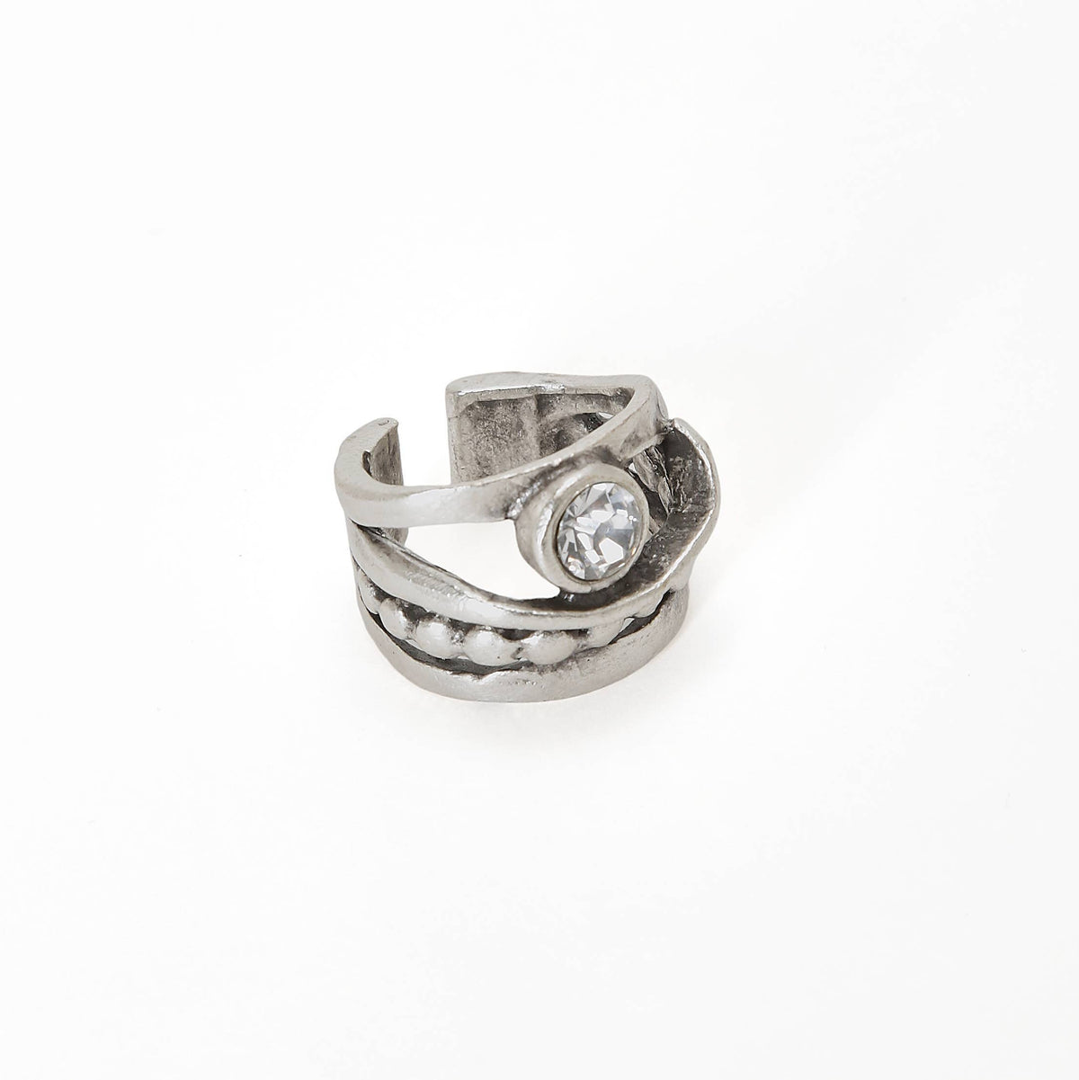 A textured silver-toned wrap ring featuring a small round clear gemstone, photographed on a seamless white background.