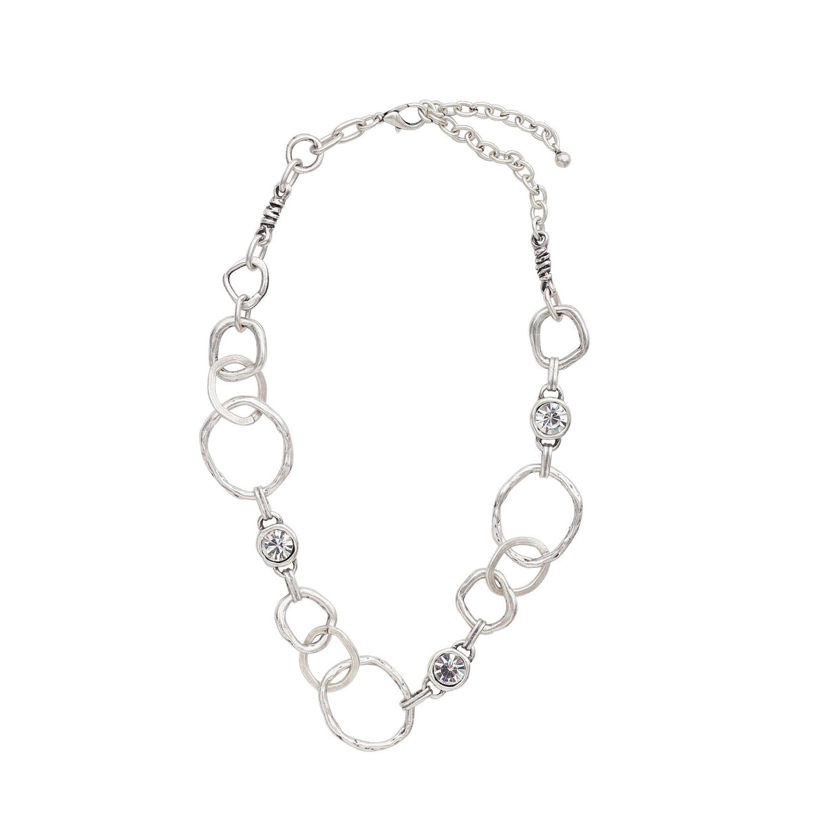A silver-toned link necklace featuring alternating textured oval links and small oval links set with clear rhinestones, displayed on a solid white background.