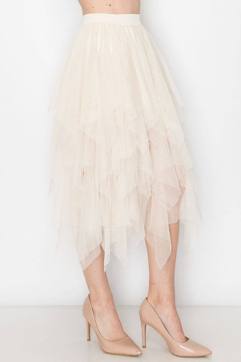 Beige tulle skirt worn by a person on a white background