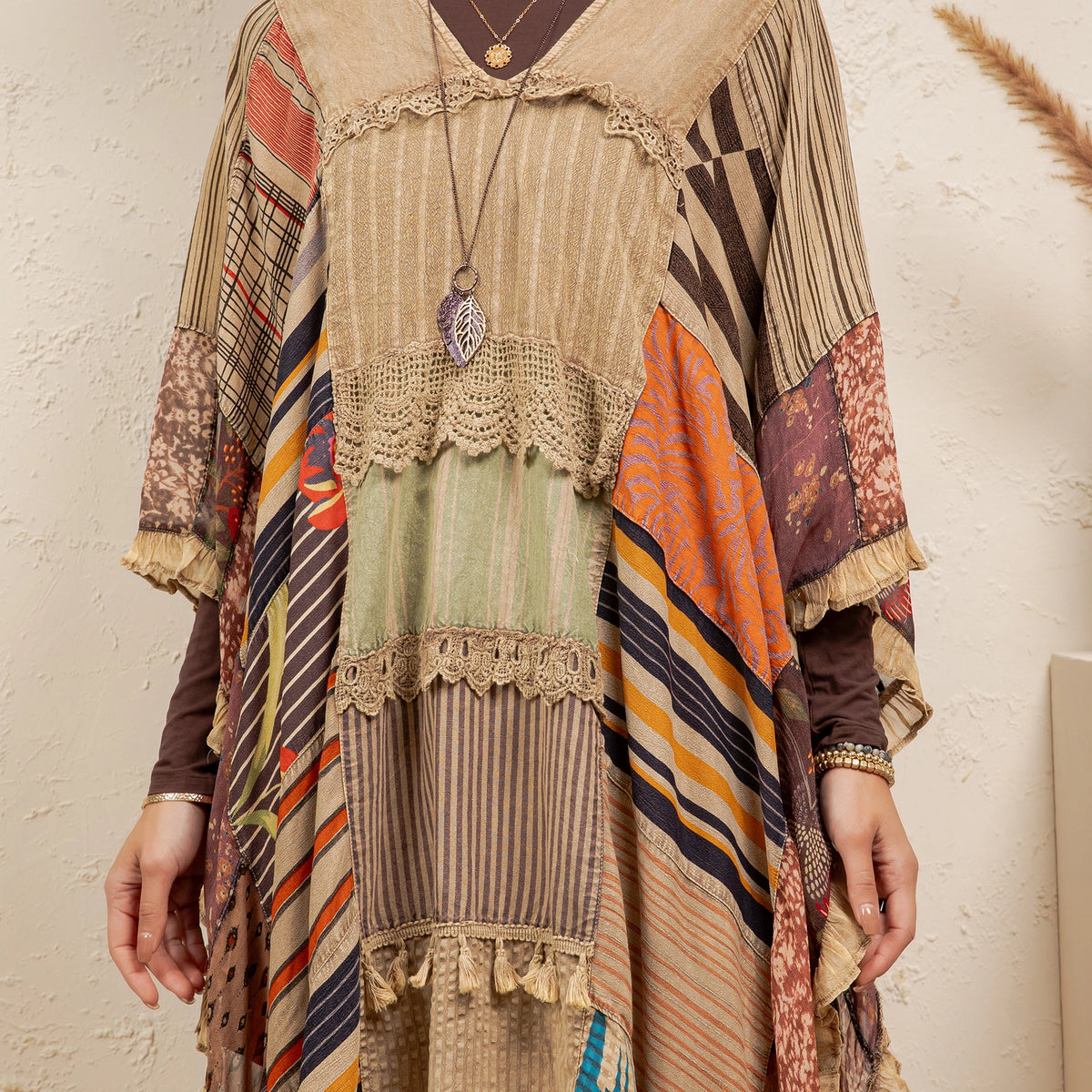 Colorful patchwork dress with intricate patterns on a neutral background