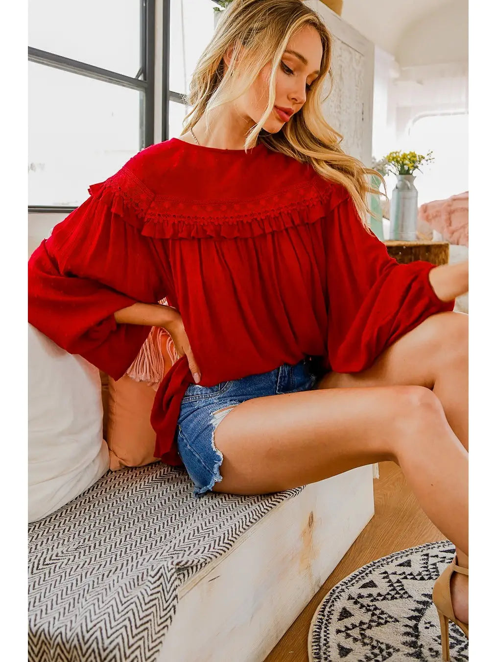 Burgundy Swiss dot boho blouse with ruffle yoke and balloon sleeves, styled with denim shorts — Spirit & Wind Boutique