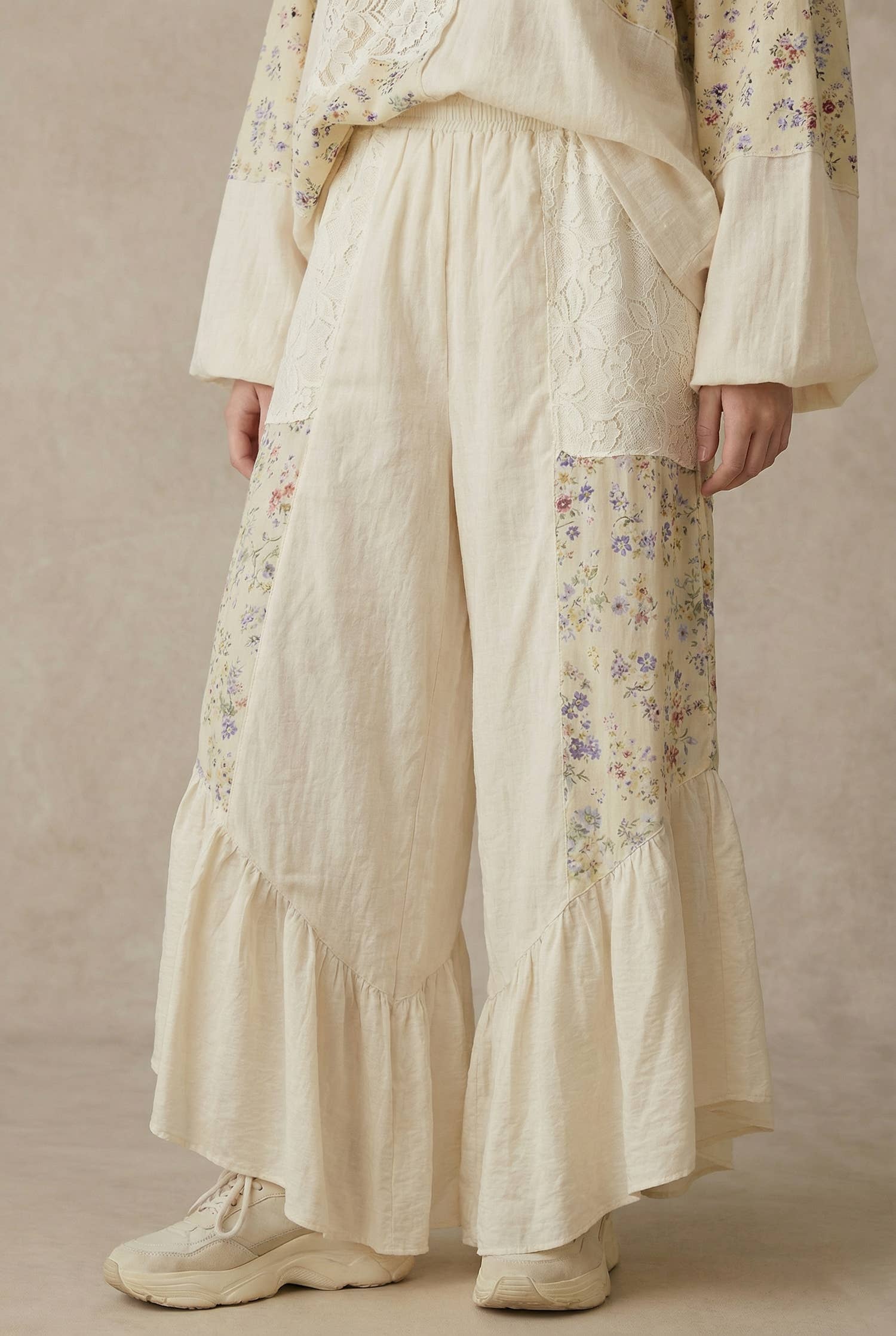 The Gypsy floral ruffle pants - front view showing artisan patchwork design with cascading ruffles and wide-leg silhouette