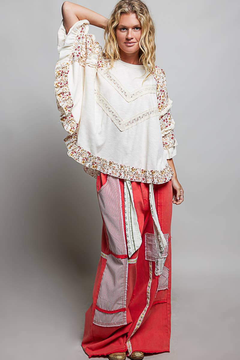 Tina's Boho Floral Lace Top in Natural – full-length lifestyle shot styled with red patchwork wide-leg pants, boho-luxe boutique look