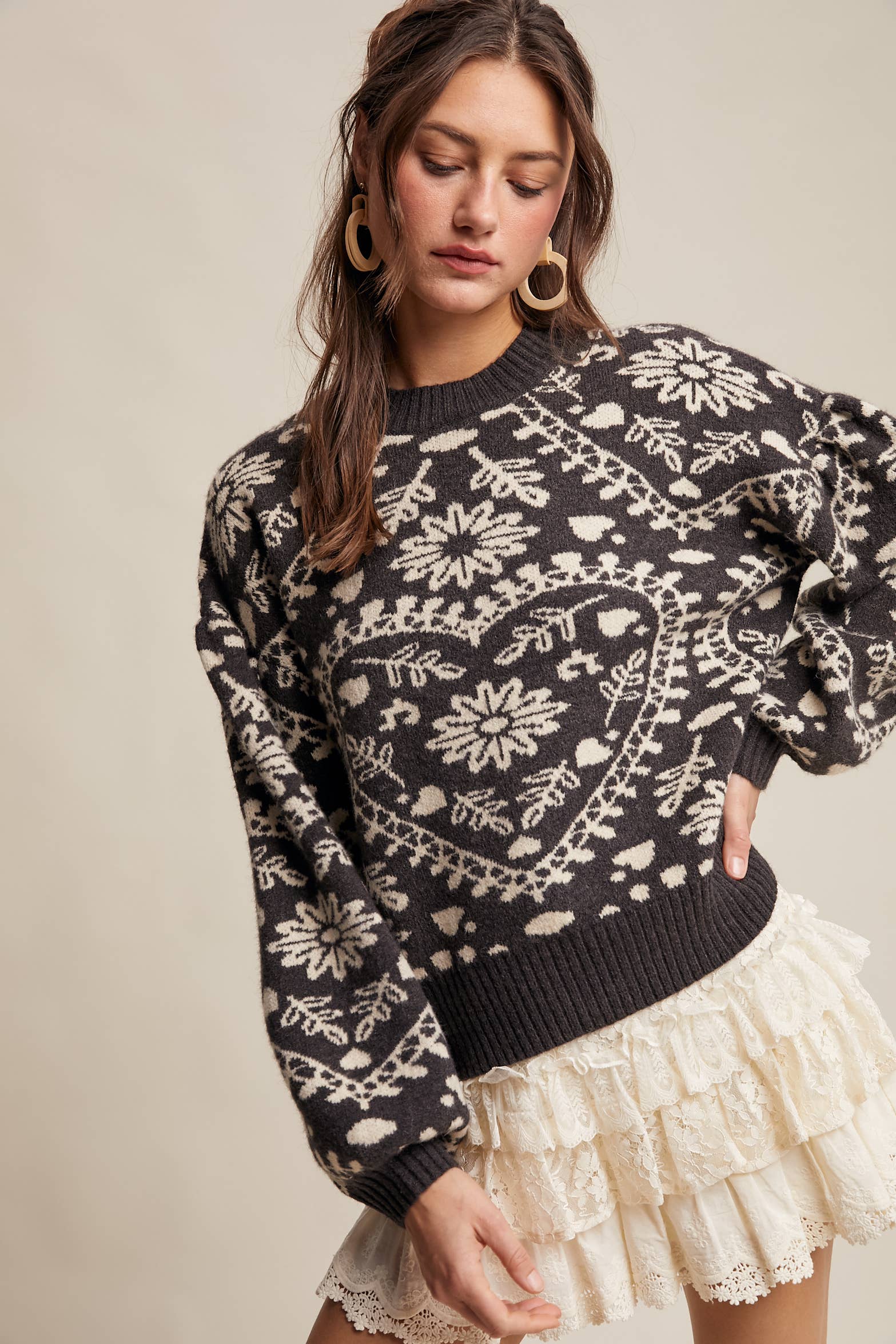 Charcoal crewneck sweater with cream floral heart–motif jacquard, puff sleeves, and ribbed cuffs and hem.