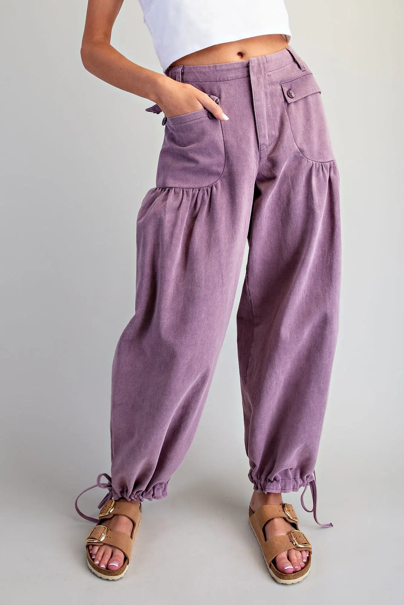 Women's mineral washed relaxed tie cuff pants in plum — boho-luxe barrel-leg silhouette with ruched pockets and drawstring ankle ties, styled with sandals