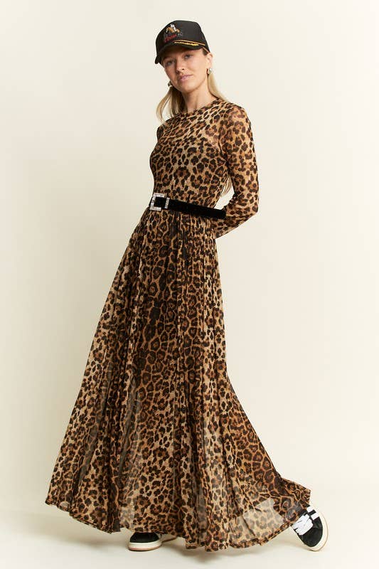Side view of a leopard-print long-sleeve mesh maxi dress with a sheer, flowy skirt, styled with a black belt, baseball cap, and black-and-white sneakers.