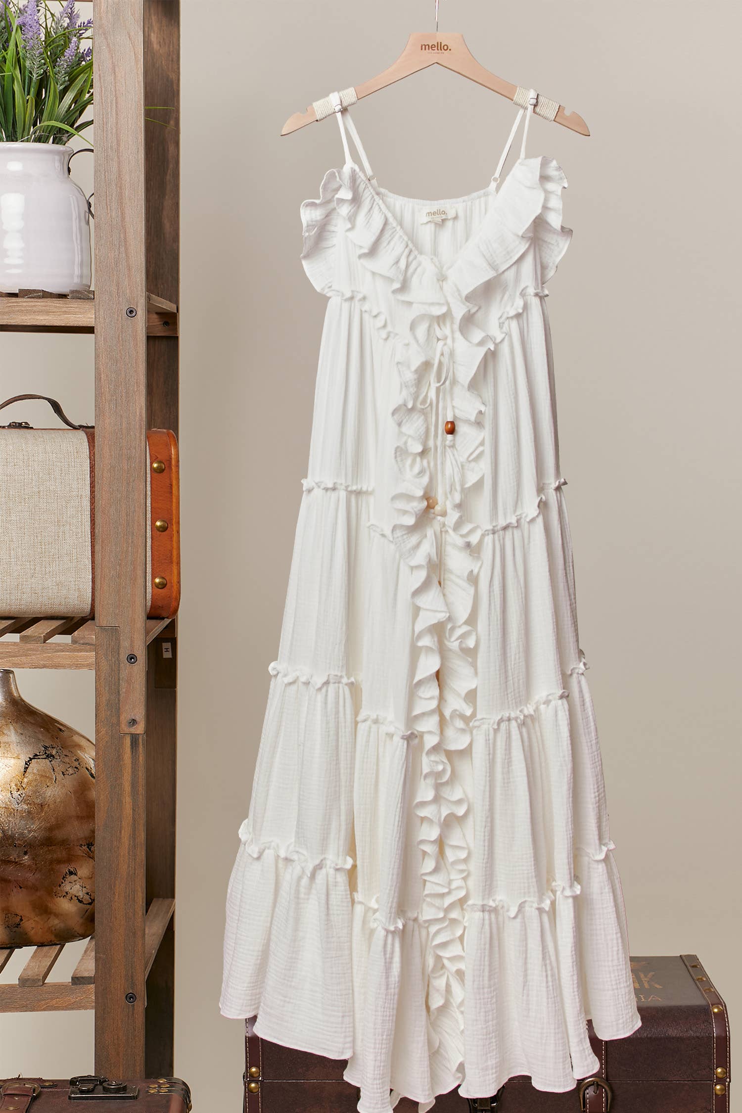 Cream ruffle cardigan dress detail - close-up of luxurious flowing fabric and  cascading ruffle construction