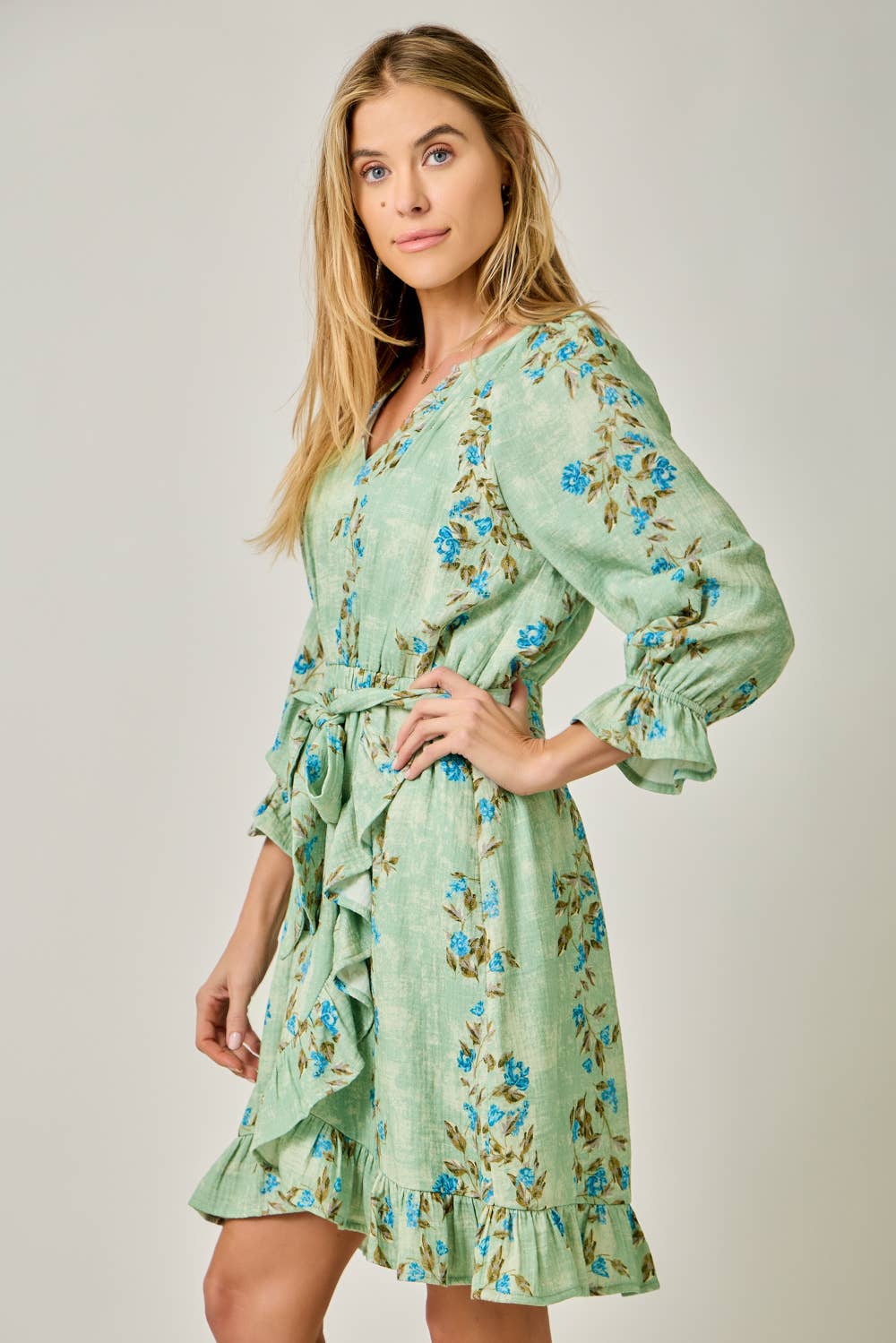The Valencia Floral Wrap Dress - side angle showing adjustable waist tie and knee-length wrap skirt
