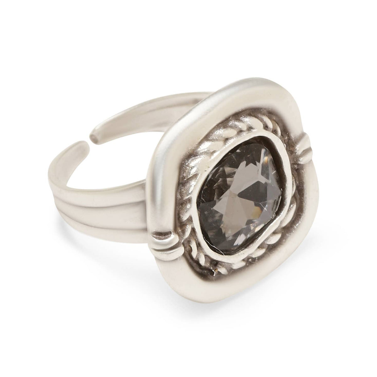 A silver-toned adjustable ring featuring a large, faceted dark gray marquise-cut gemstone in a decorative bezel setting with a twisted rope border.