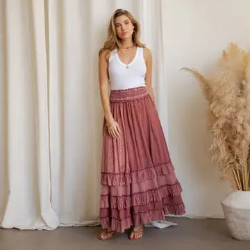 Garnet Artisan Panel Maxi Skirt - front view showing smocked waist, mixed patchwork panels, and tiered ruffle hem styled with strappy sandals