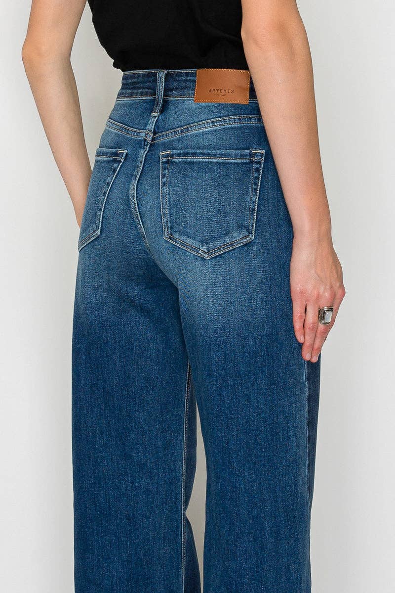 Close up back view Flare jeans hem detail - unique polished hem treatment on dramatic long flare silhouette

