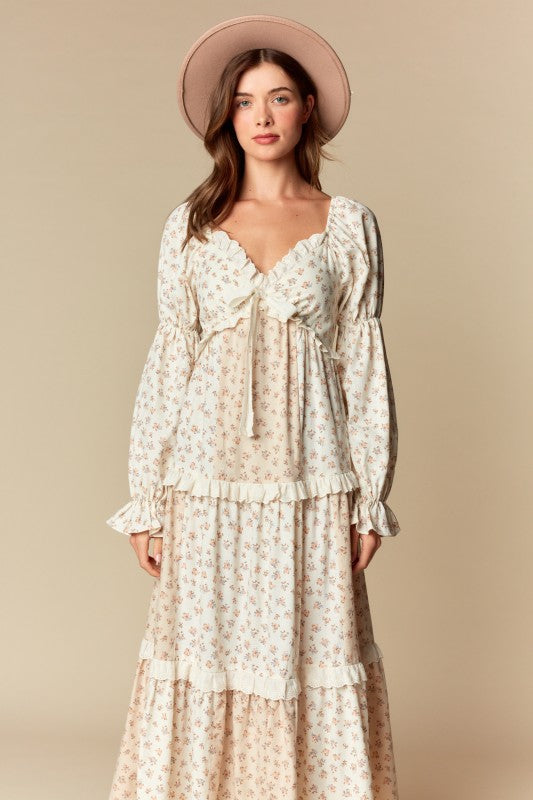 Cream/blush ditsy floral tiered maxi dress, ruffle trim, long puff sleeves, tie-front sweetheart neckline, front view on model.