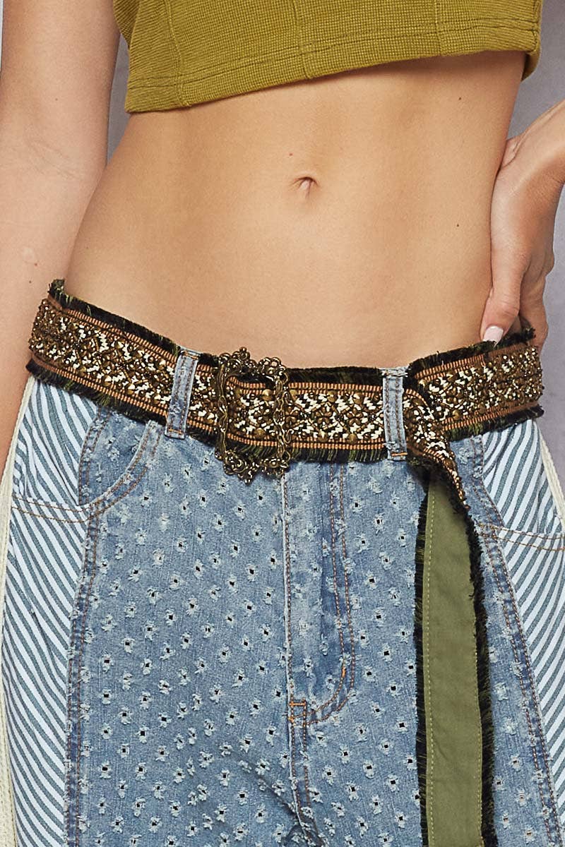 Decorative boho belt with intricate stitching and buckle, adding luxe detail to casual denim.