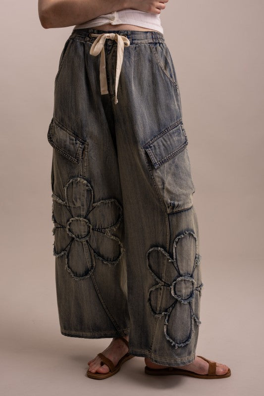 Wide leg flower patchwork cargo denim pants with raw-edge daisy appliqués and drawstring waist — boho luxe style