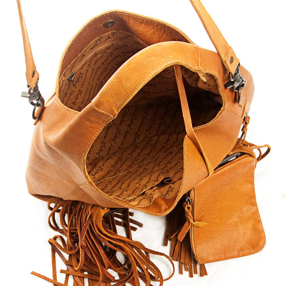 Brown leather handbag with fringes on a white background