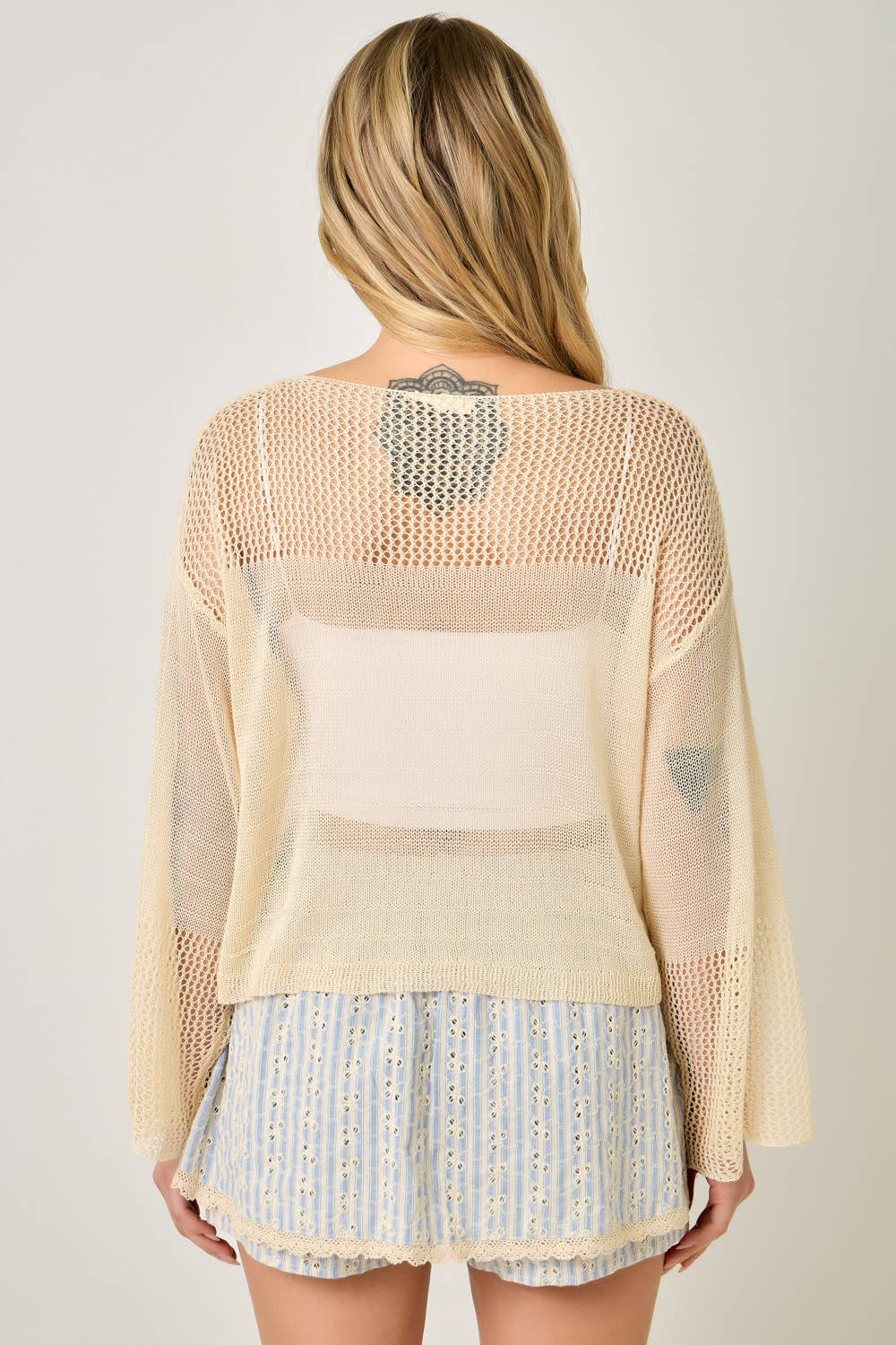 The Barely There Knit in Oatmeal - back view of relaxed sweater silhouette

