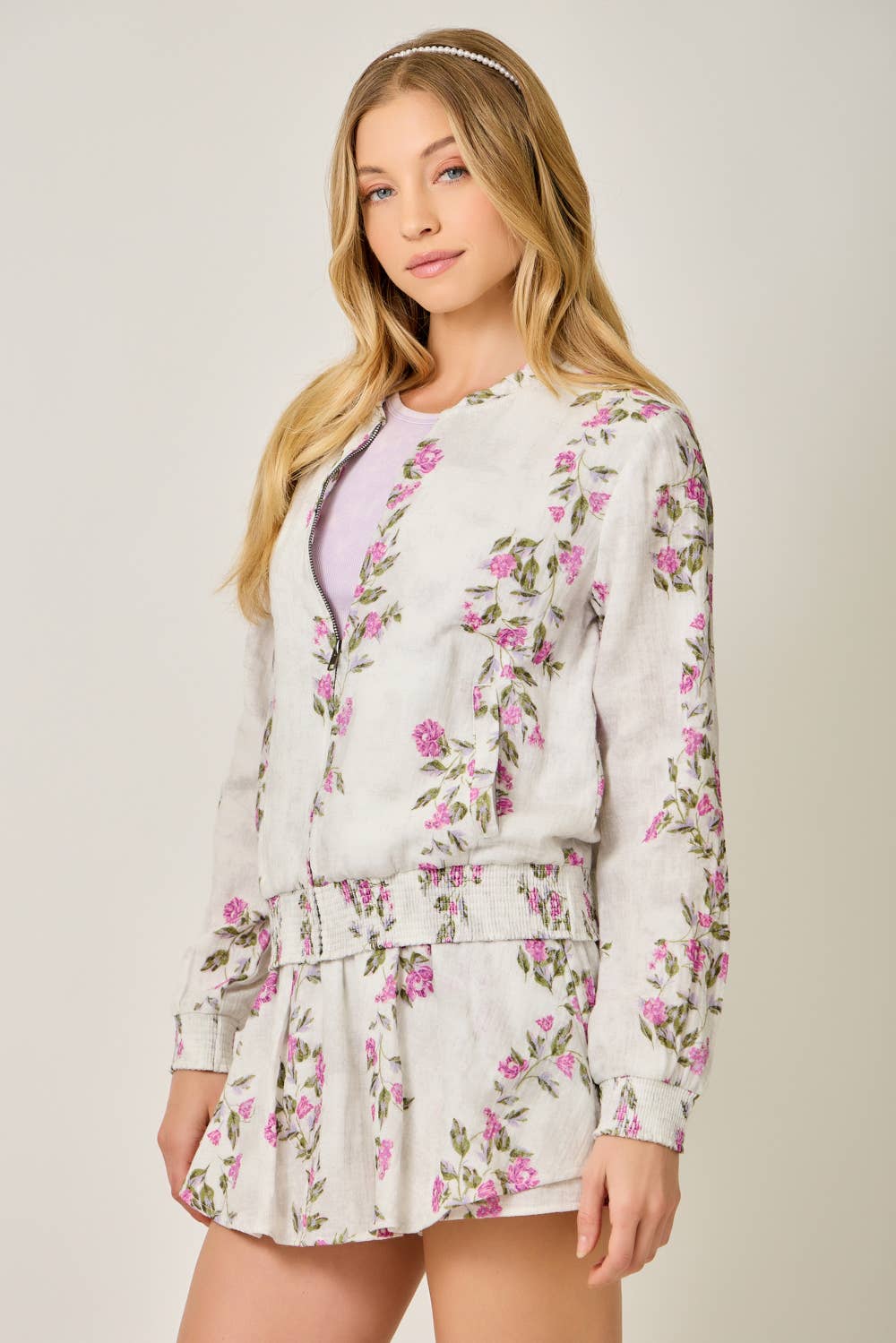 The Rosewood Floral Bomber - side angle showing flattering smocked waist and side pockets