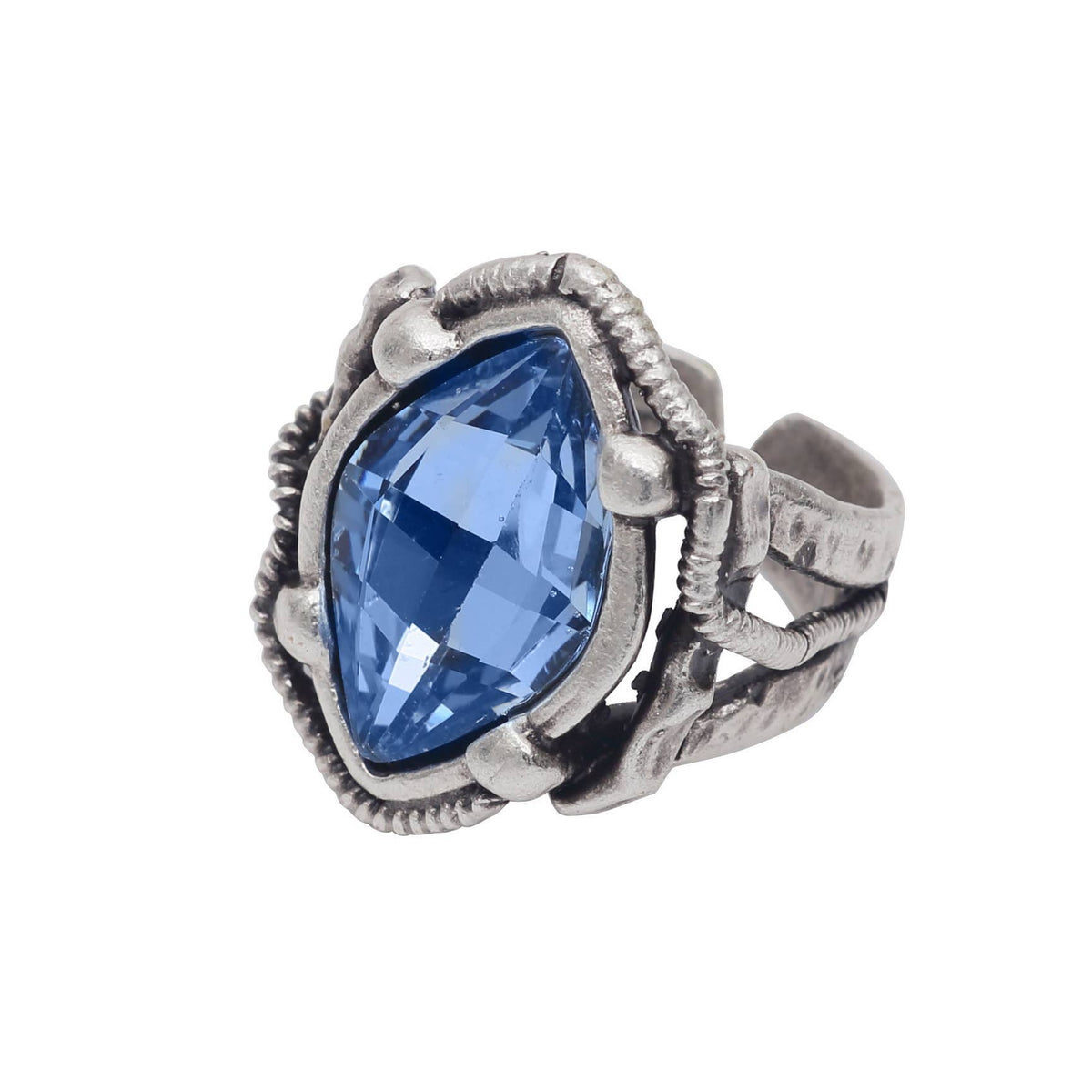 A silver-toned ring featuring a large, faceted marquise-cut blue gemstone in an ornate, textured setting, shown against a plain white background.