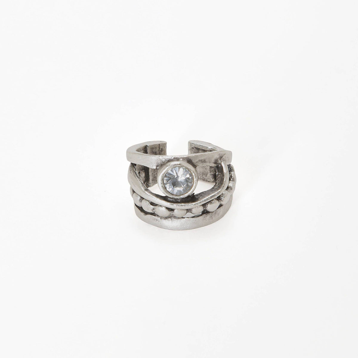 A textured silver-toned ring with a central clear round gemstone, photographed on a seamless white background.