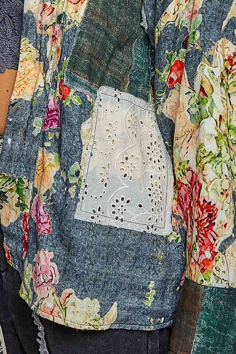 Close view of the green floral and plaid patchwork details on the Peace in Bloom reversible jacket
