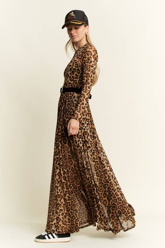 Side view of a leopard-print long-sleeve mesh maxi dress with a sheer, flowy skirt, styled with a black belt, baseball cap, and black-and-white sneakers.