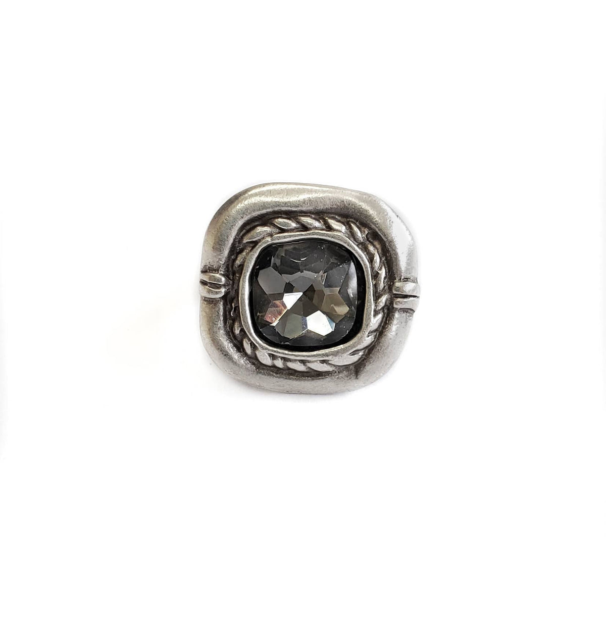 A square silver-toned ring featuring a central dark gray faceted gemstone, set in a textured, rope-wrapped bezel on a plain white background.