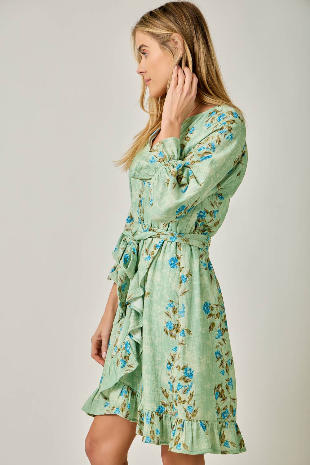The Valencia Floral Wrap Dress - side angle showing adjustable waist tie and knee-length wrap skirt