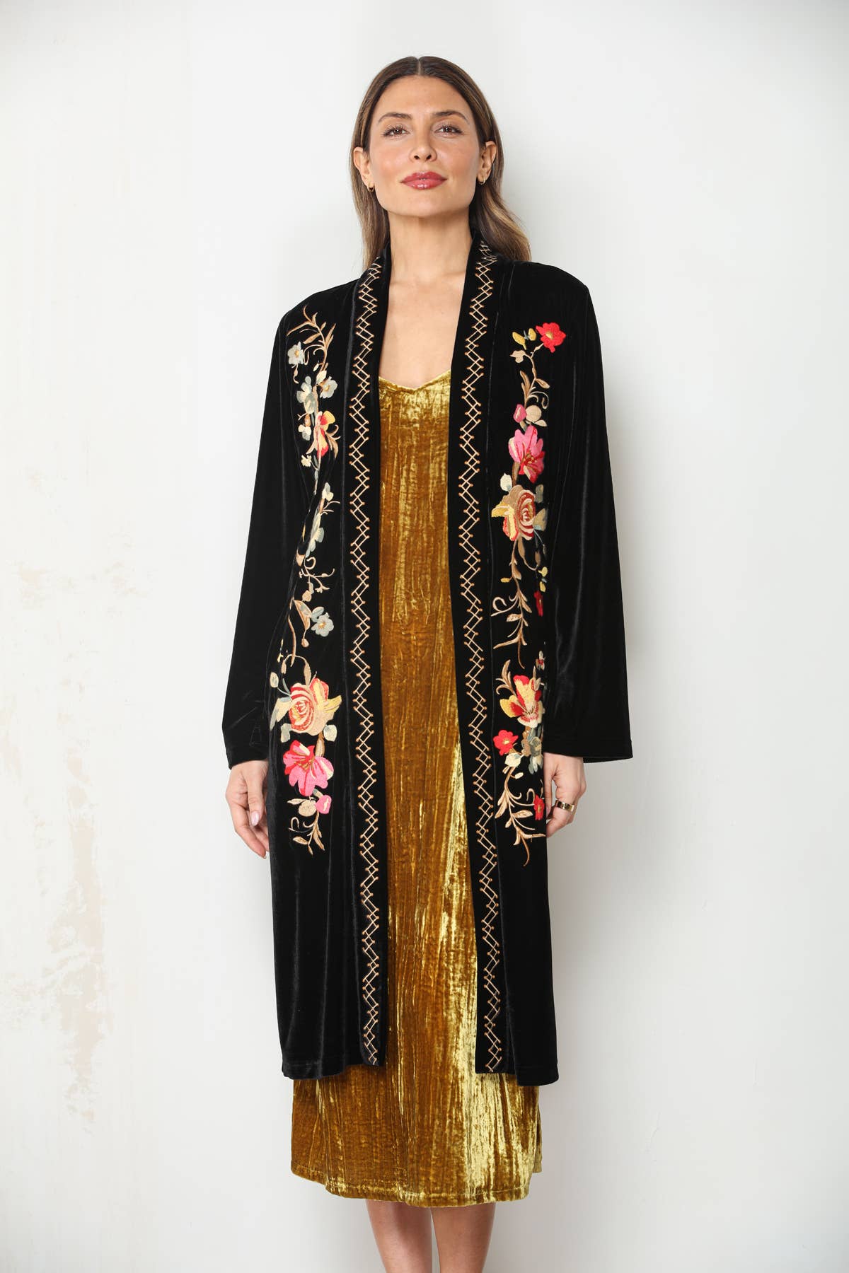Closer front view of Midnight Bloom black velvet duster showing pink and cream floral embroidery and stitched trim.