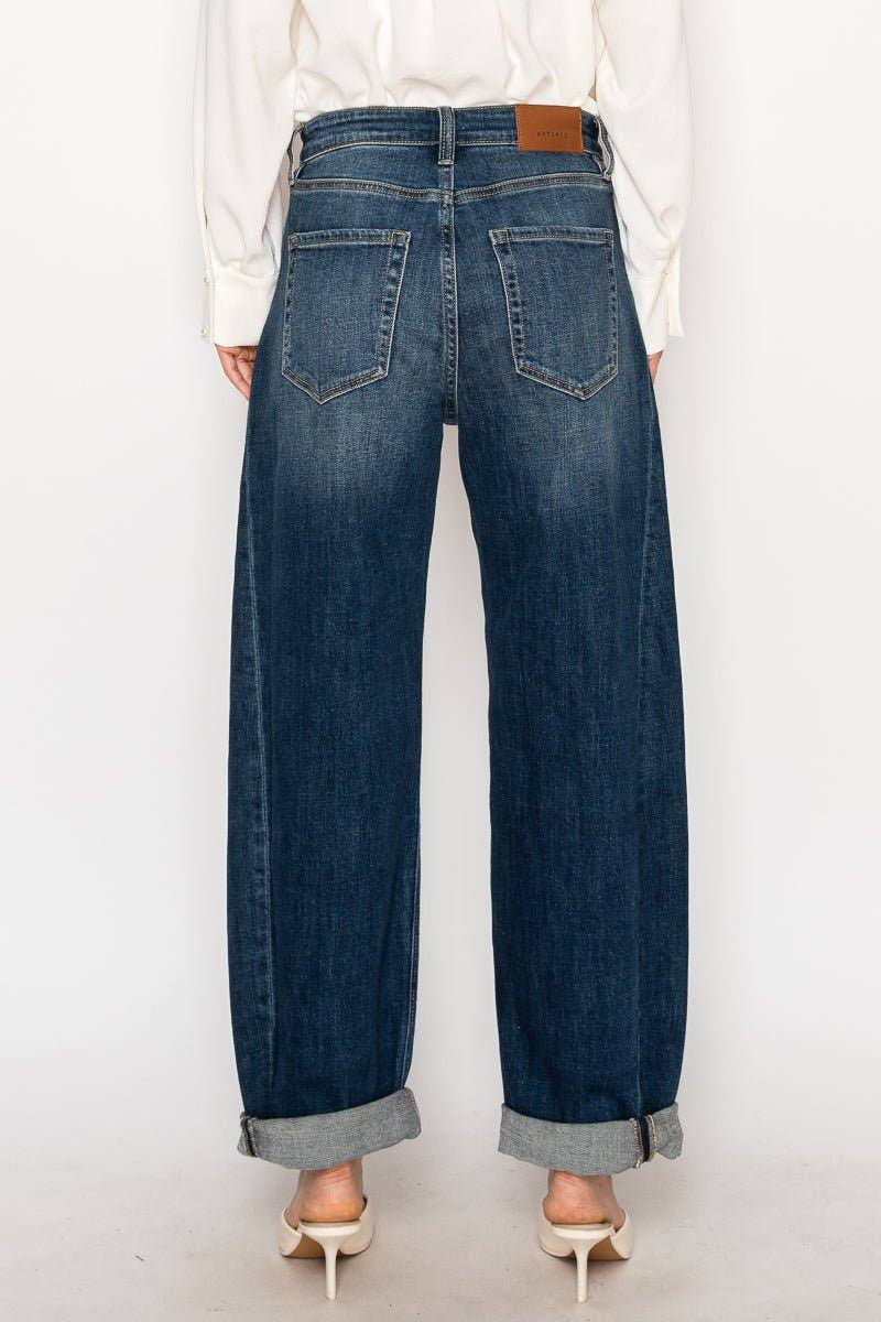Person wearing blue jeans with a white background