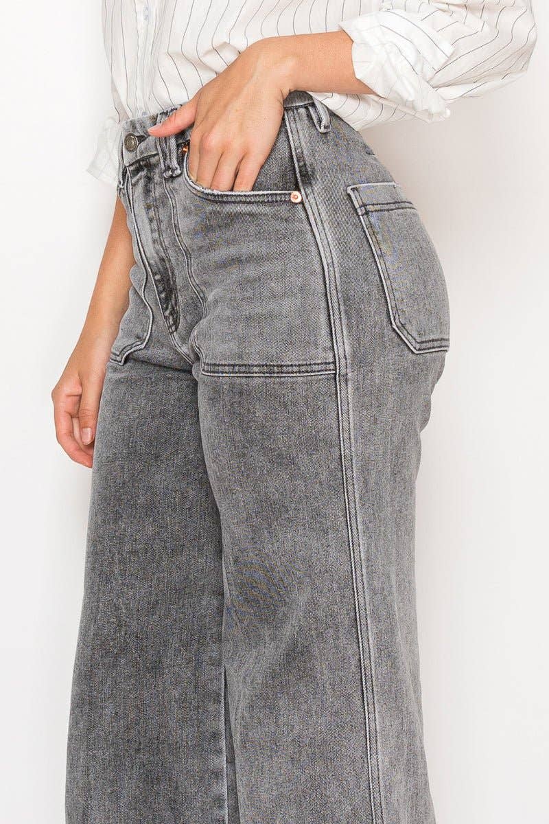 Person wearing gray high-waisted jeans against a white background