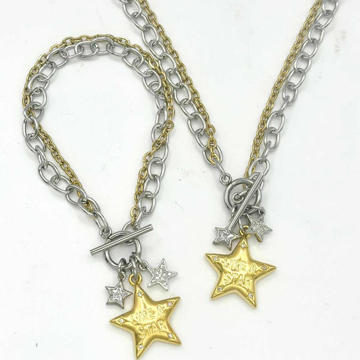 Necklace & Bracelet: Mixed-metal necklace with silver- and gold-tone chains, a toggle clasp, two small silver stars, and a gold star engraved “Like a Star.”

