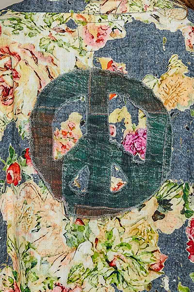 close up Back view of the Peace in Bloom green floral reversible jacket showing its patchwork design
