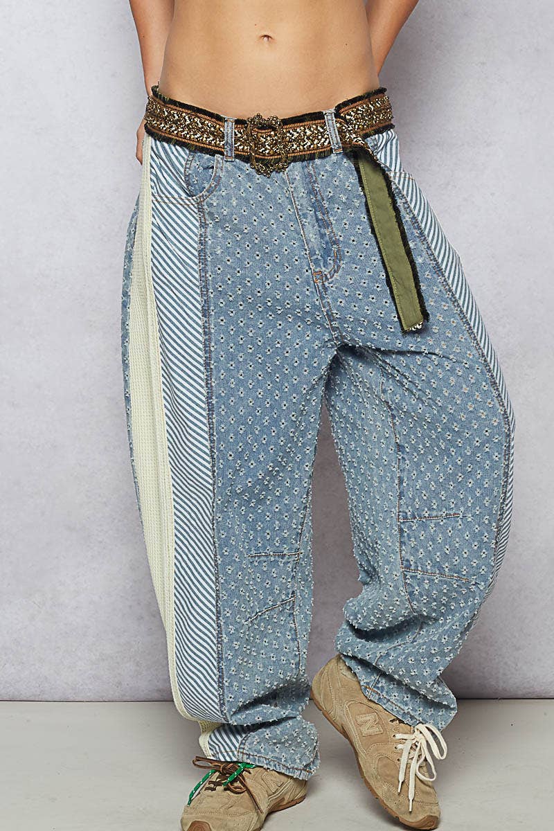 Decorative boho belt with intricate stitching and buckle, adding luxe detail to casual denim.