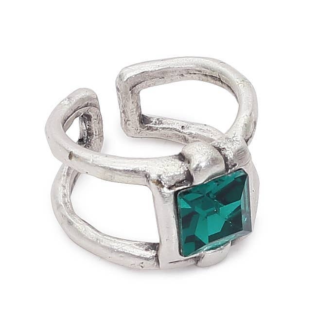 Silver ring with a green gemstone on a white background