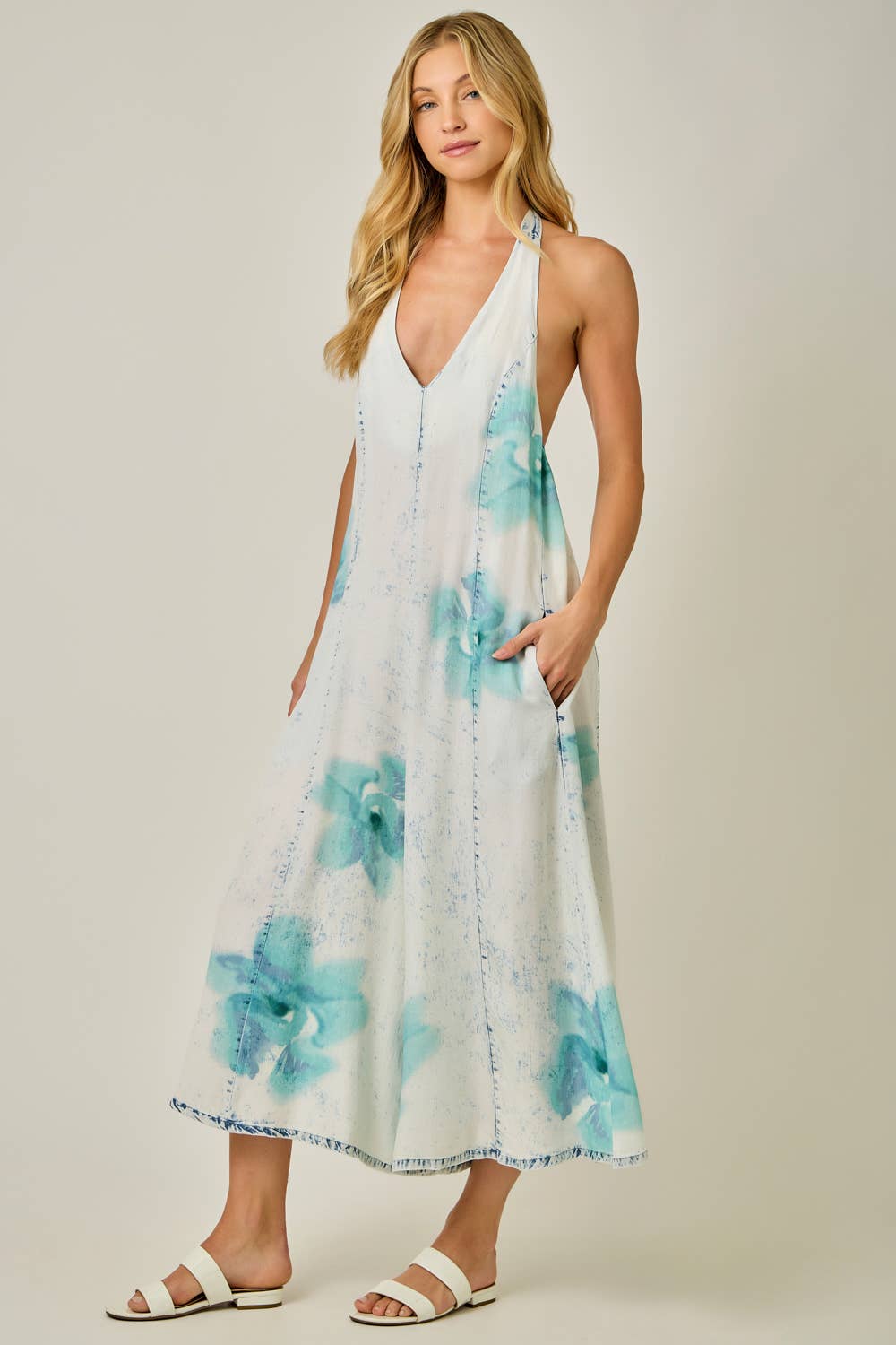 Woman wearing a floral Jumpsuit with a plain background