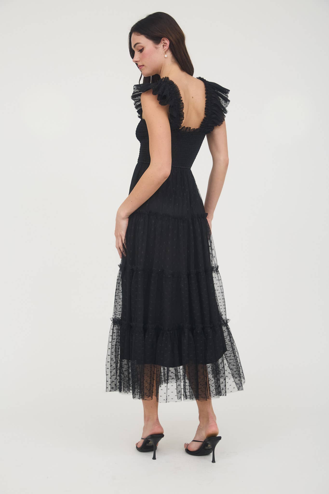Black dress with ruffled back on a white background