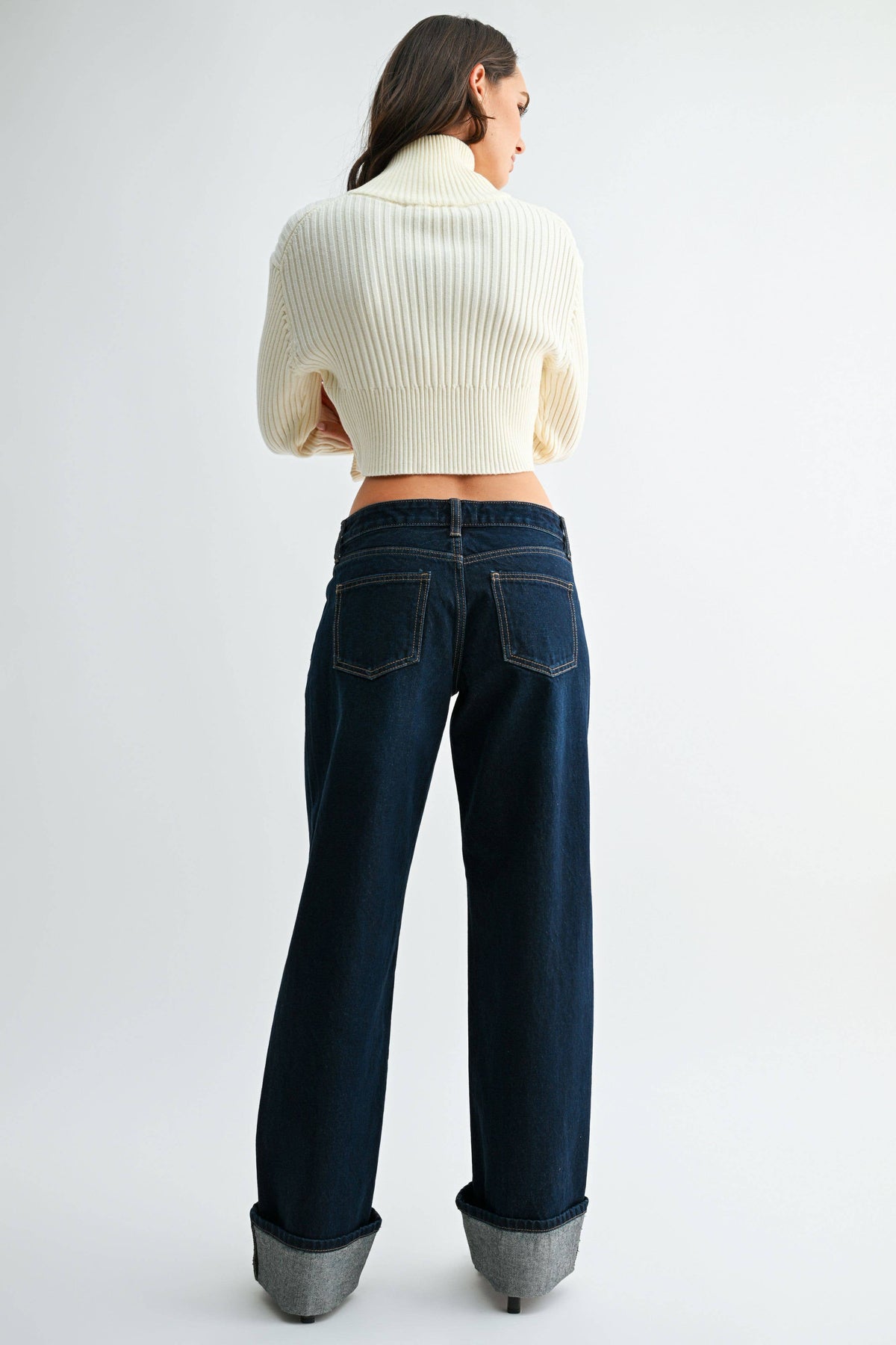 Back view of Midnight Edge Cuffed Jeans showing two back pockets, contrast stitching, and oversized cuffs.
