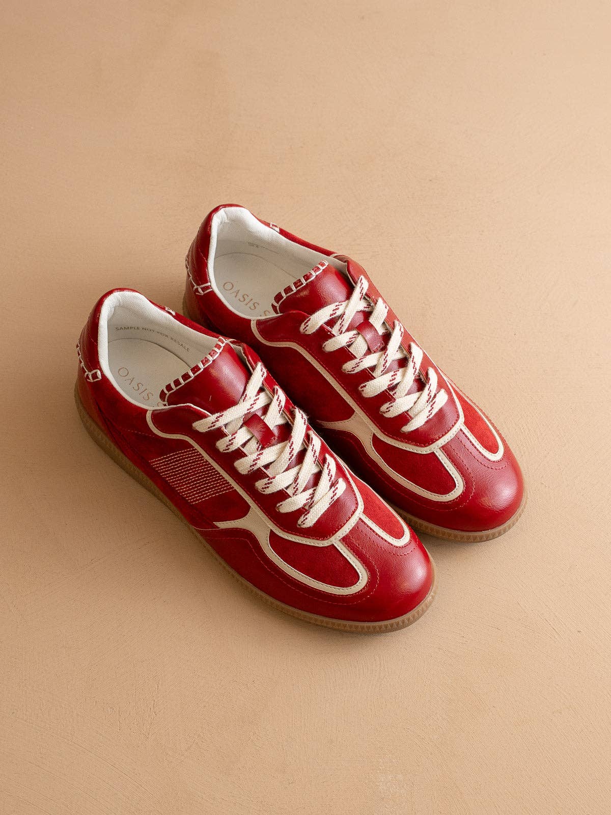 Cherry red Oasis Society sneakers with cream detailing and two lace options — organza ribbon and classic cotton.