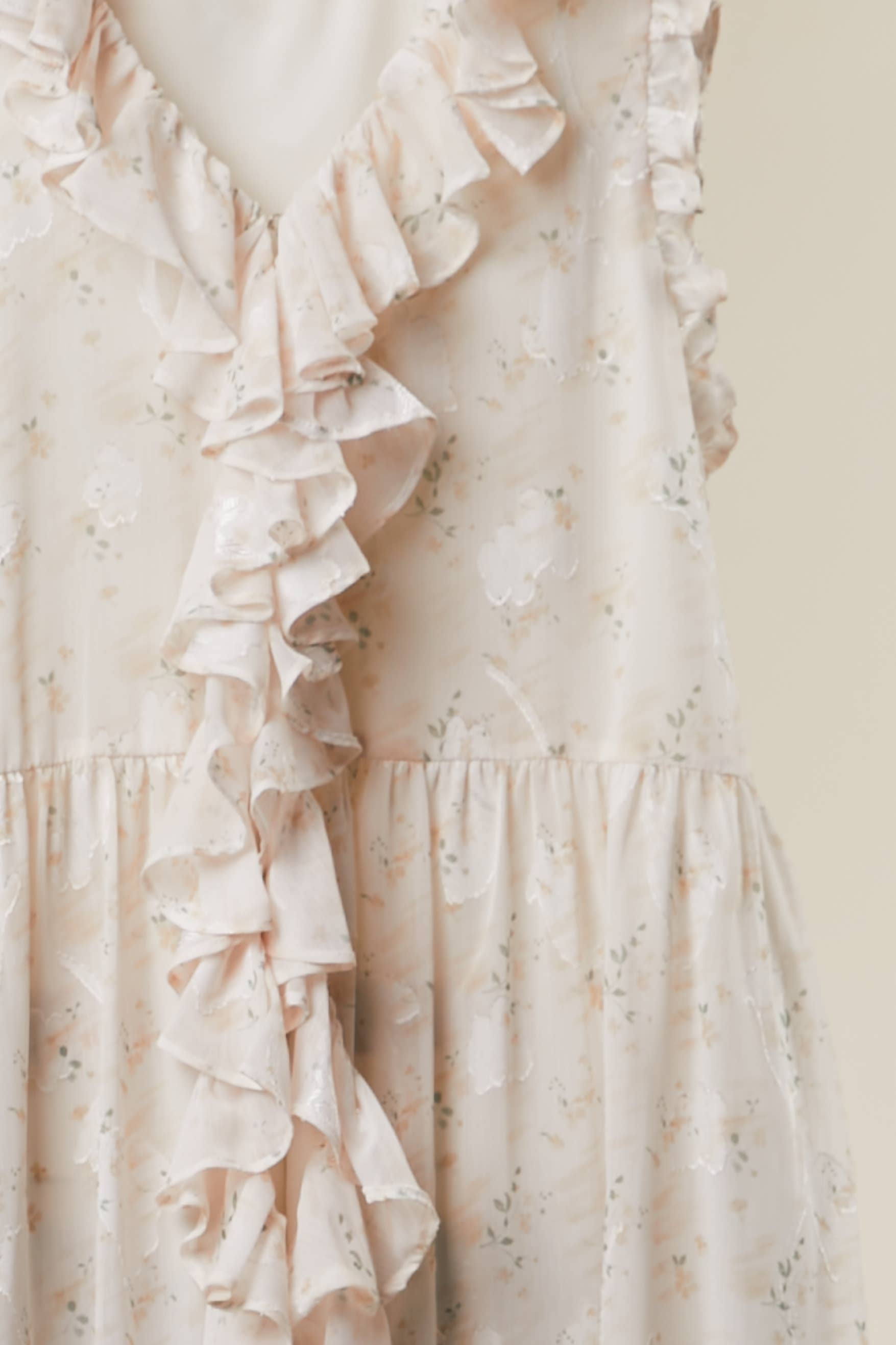 Floral ruffled tunic in white - front view showing delicate ruffle detailing and flowy silhouette


