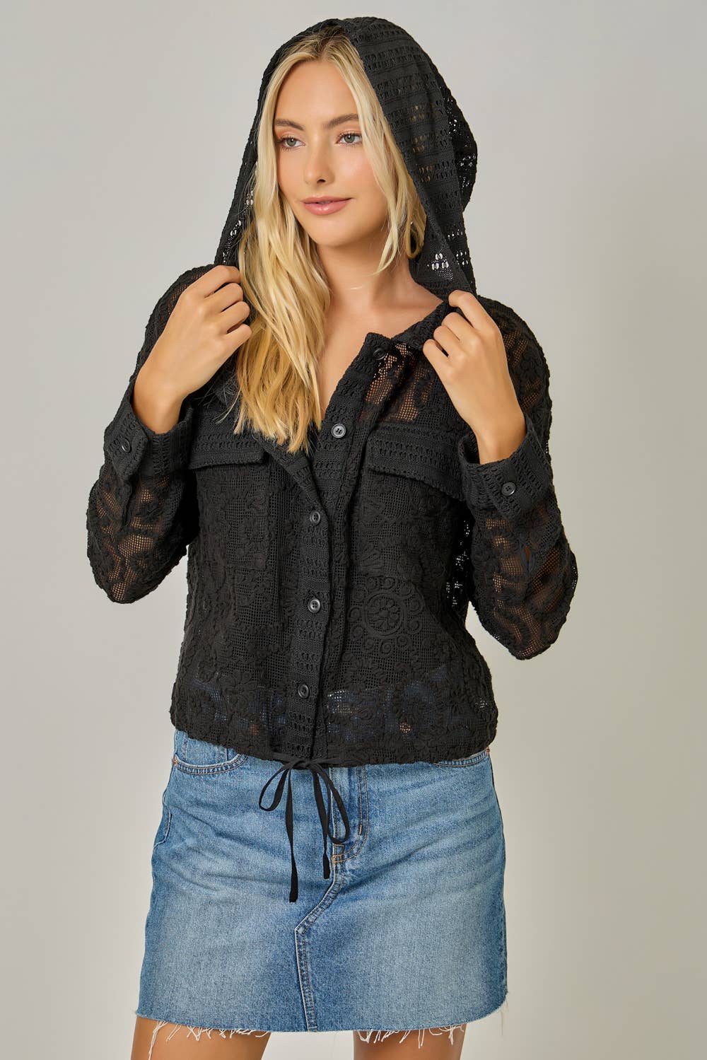 Crochet Lace Drawstring Hoodie Jacket in Black — button-down front, chest pockets, drawstring waist, and long sleeves in delicate crochet lace with hoodie on model

