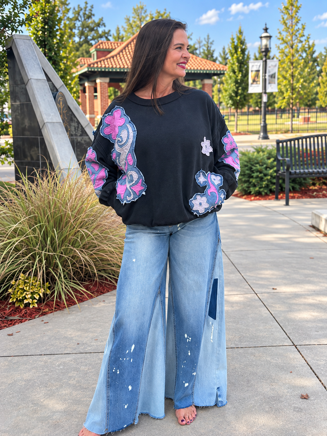 Women’s mineral-wash sweatshirt with floral denim patchwork detail and pockets on the sweatshirt
