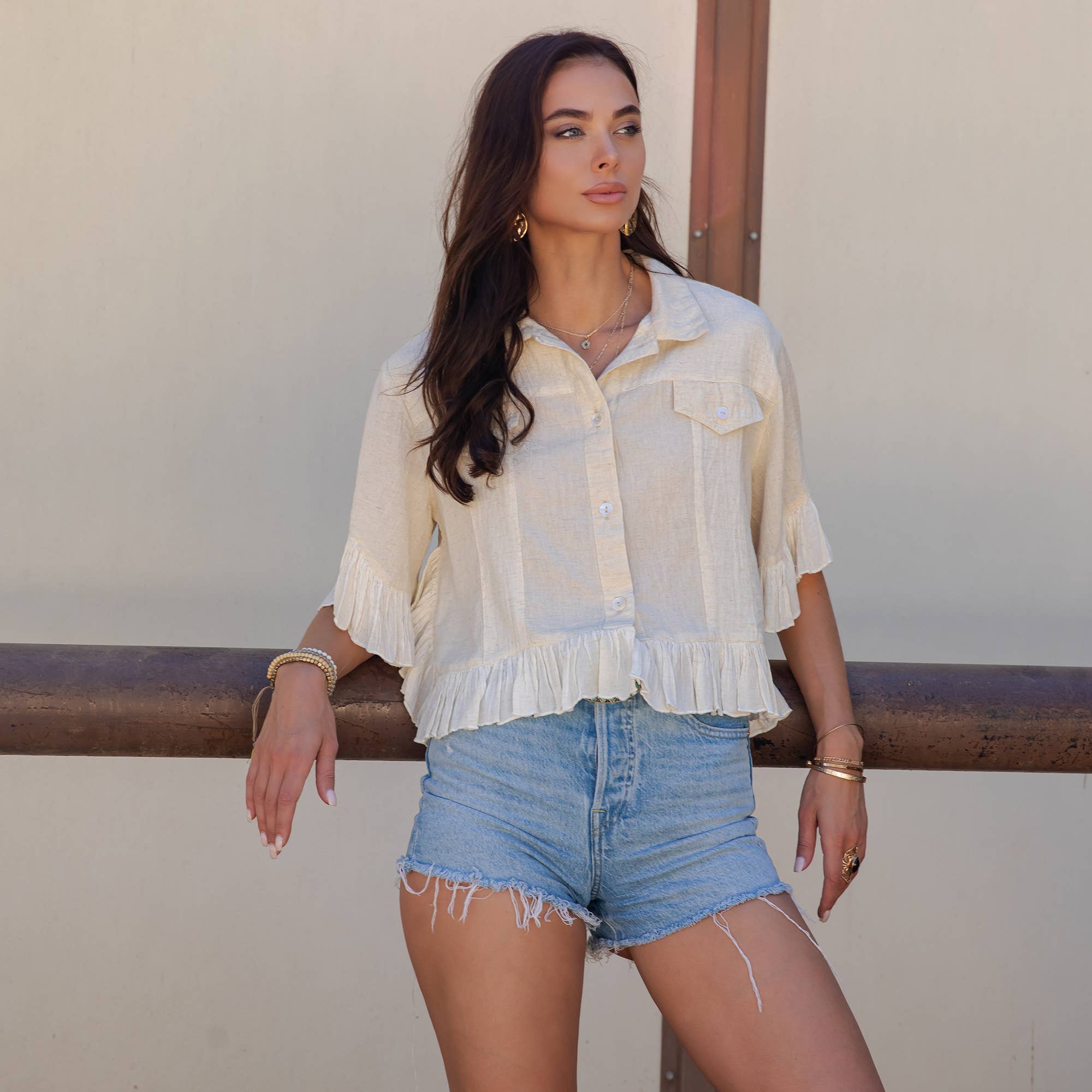The Rebel Cropped Denim Shirt - close-up of ruffled hem and textured fabric construction

