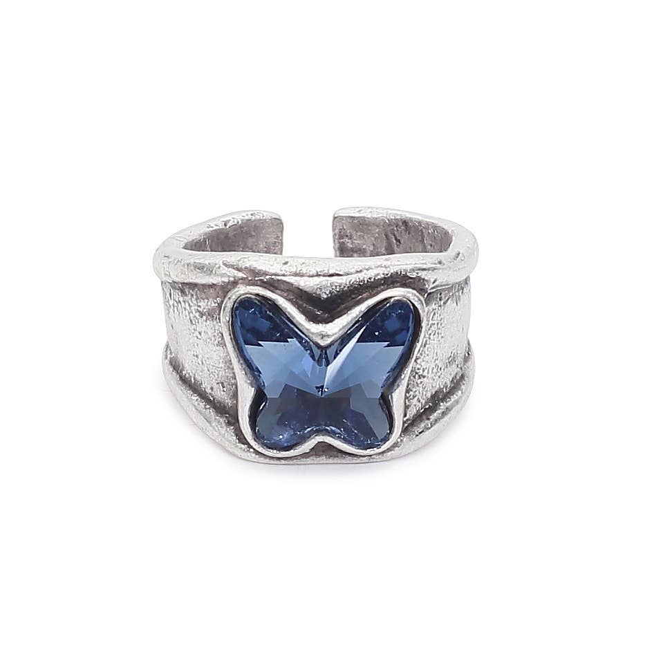 A silver-toned textured ring featuring a central butterfly-shaped blue gemstone, shown on a plain white background.
