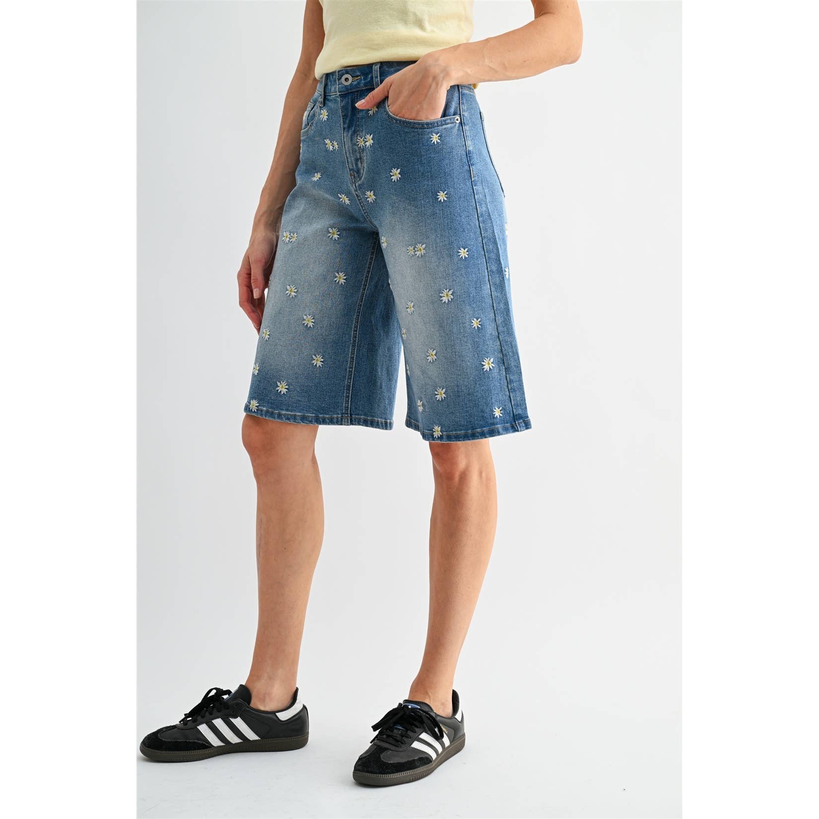 Side view of lady wearing model wearing Daisy Field Bermuda Short by Mica Denim