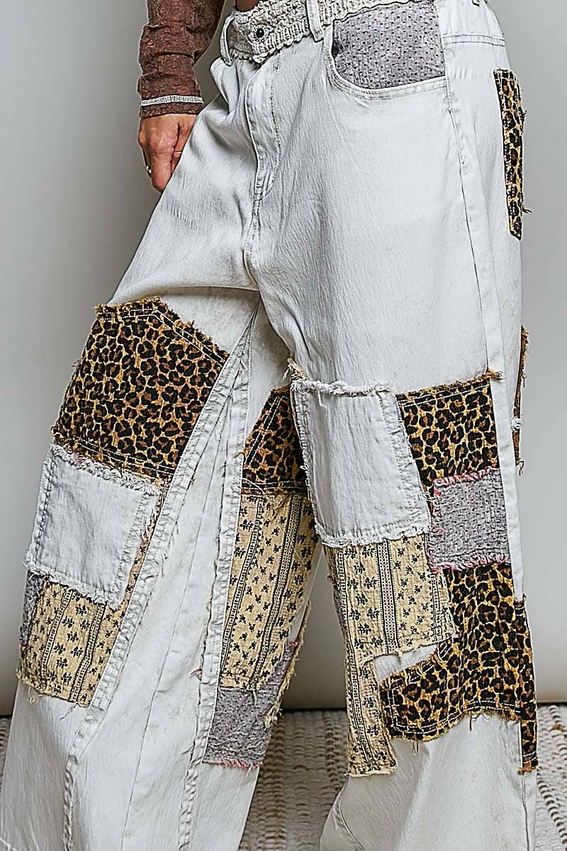 White jeans with leopard print patches worn by a person.