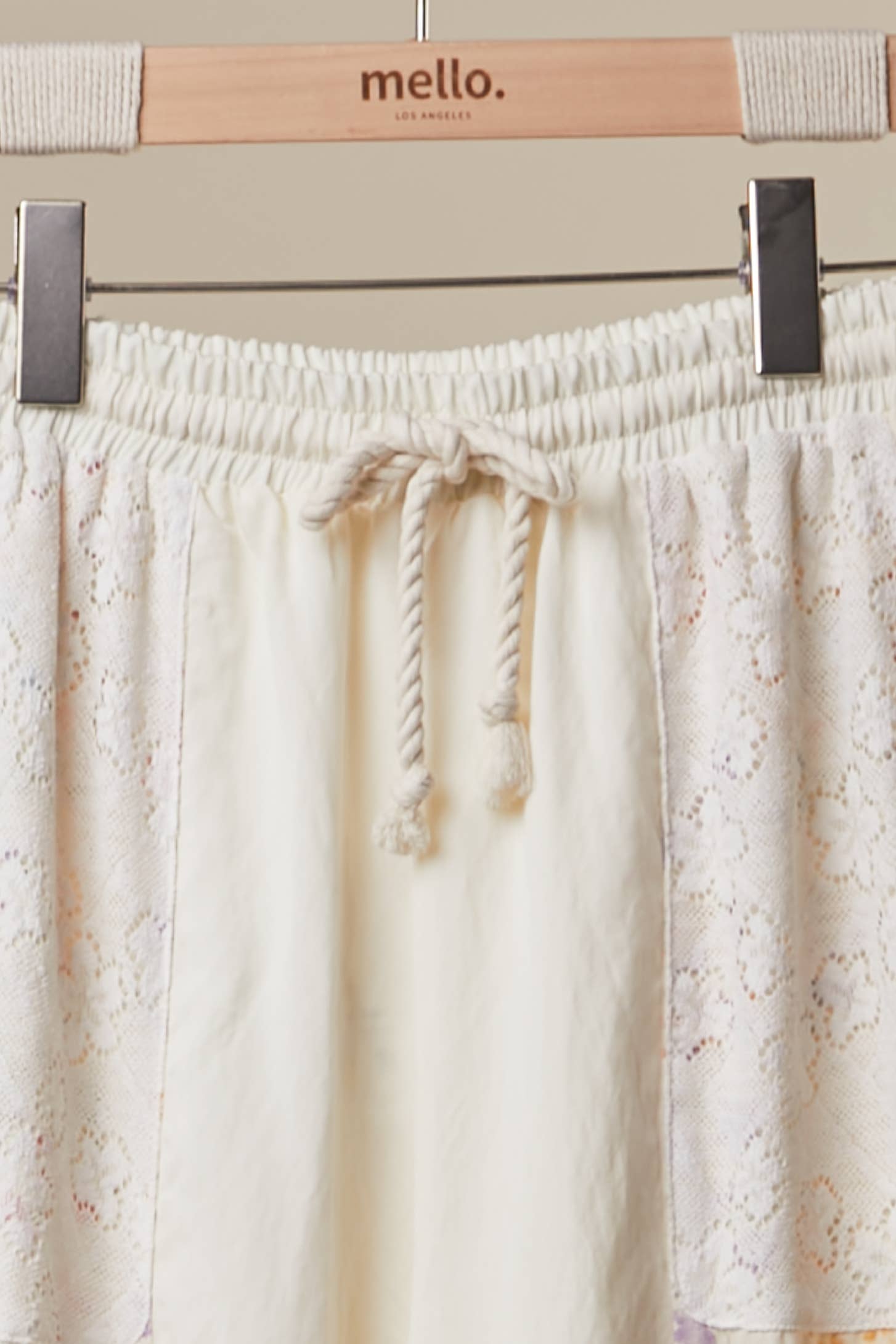  Floral patchwork pants detail - close-up of unique mixed floral prints and romantic ruffle accents