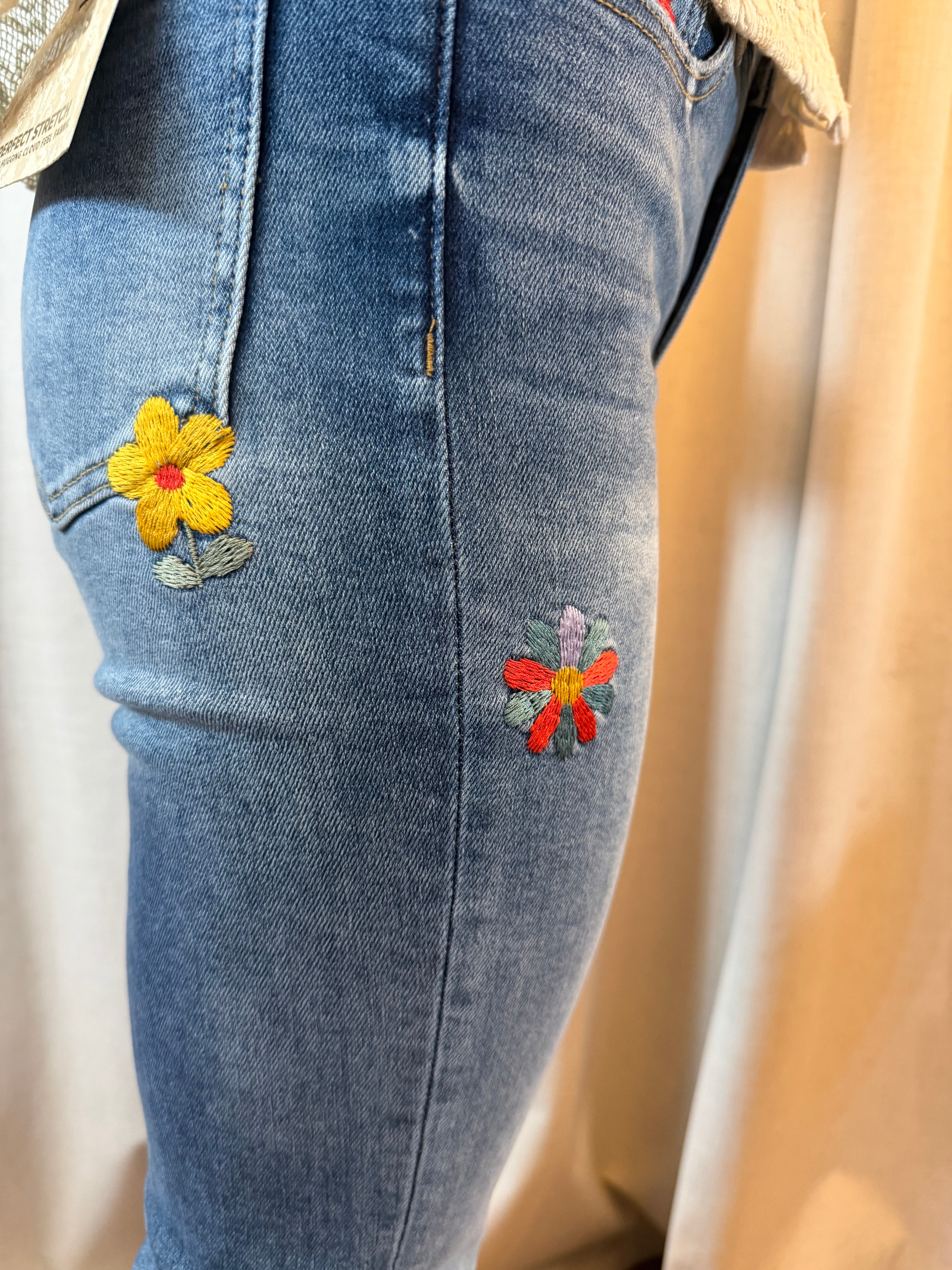 Side view close up of Flower Embroidered Mid Rise Bootcut Jeans in Medium Blue
